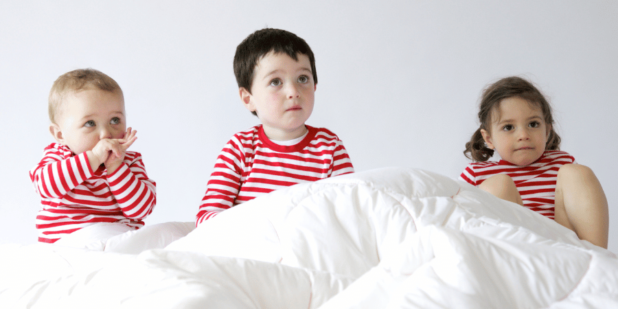 3 kids in a bed